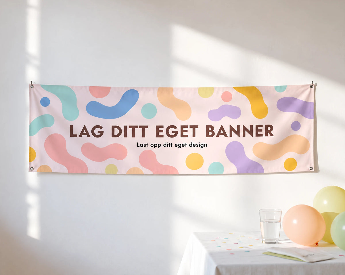 Liggende banner 130 × 40 cm i pastell med teksten Lag ditt eget banner, hengende på vegg over festbord med ballonger
